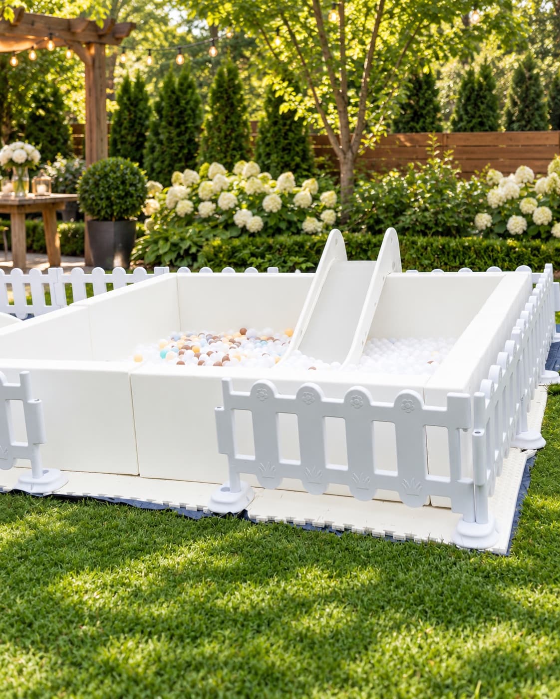 White ball pit with slide set up outdoors